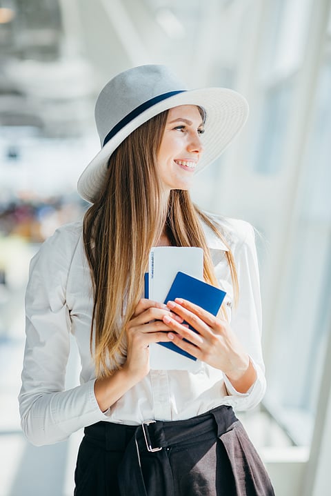 An elegant tourist carrying her necessary travel documents