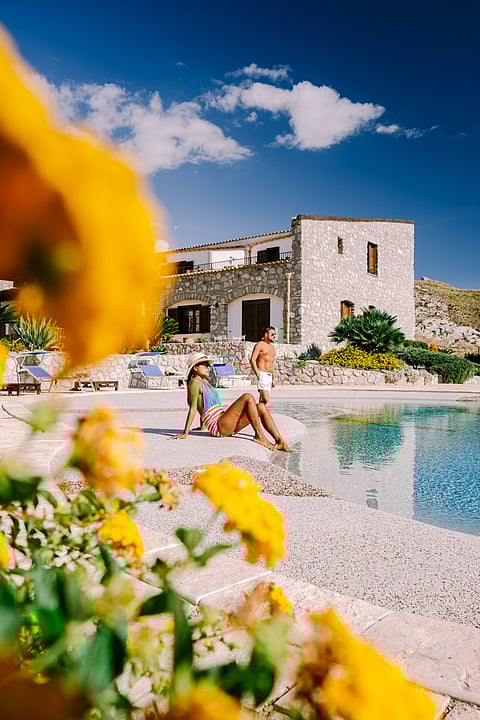 A couple by the pool at an Agriturismo in Sicily, Italy