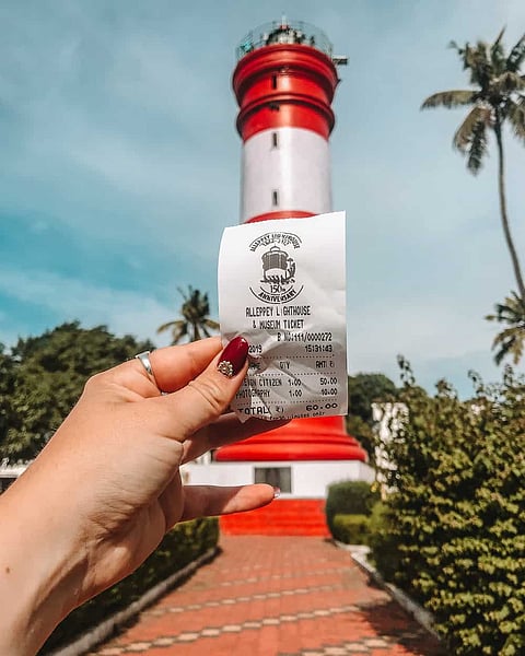 A woman holds her ticket to the Alappuzha Lighthouse Museum