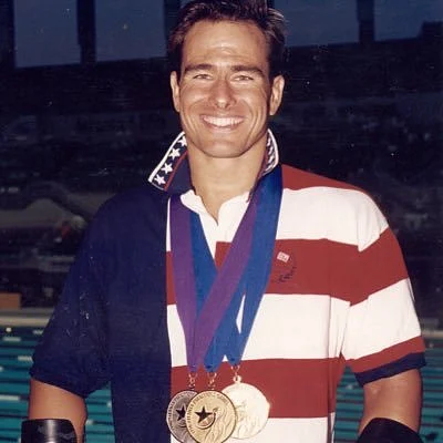 Burns has represented the USA as a Paralympic swimmer, bringing home medals in the 1992, 1996, and 2000 Games