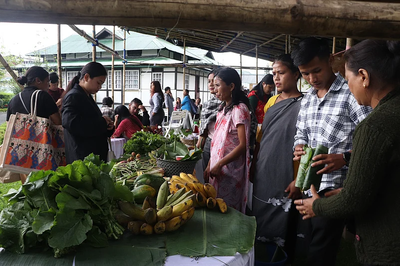 Visitors browse through local produce at a farmers market