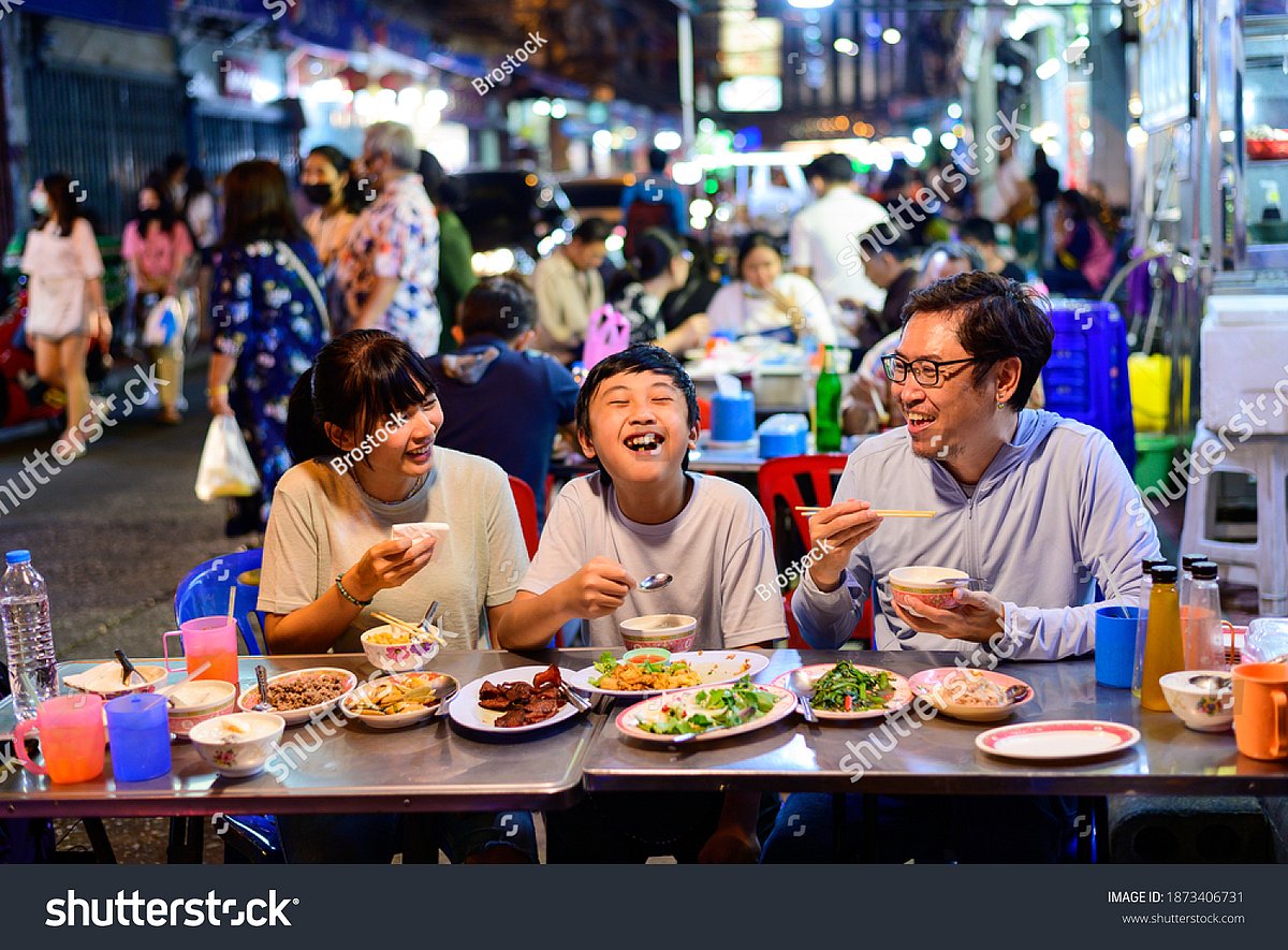Families enjoying street food