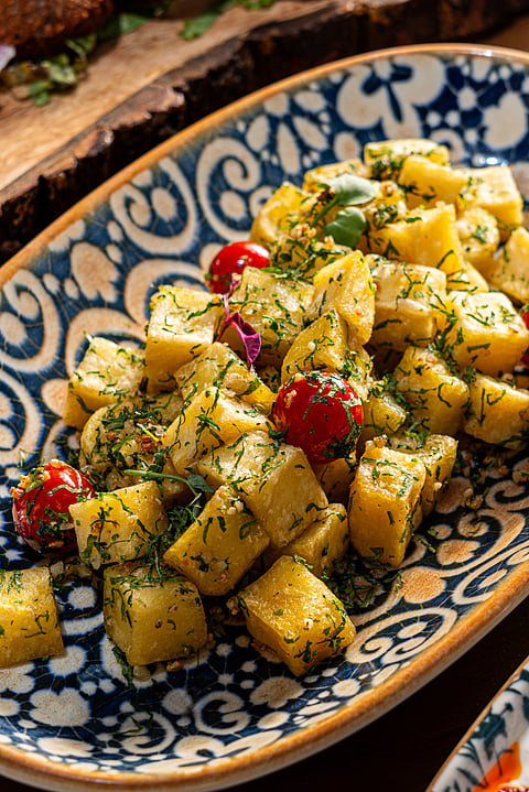 The batata harra is crispy fried potato cubes tossed in a garlicky sauce with garnish