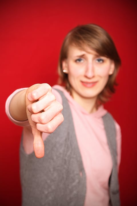 A woman gives a gesture symbolising a 'No'