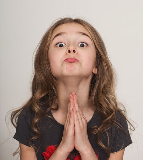A girl gestures with her hands as she pleads for her case