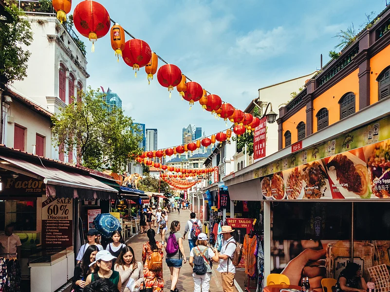 Tourists strolling around the various souvenir market stalls in Singapore Chinatown