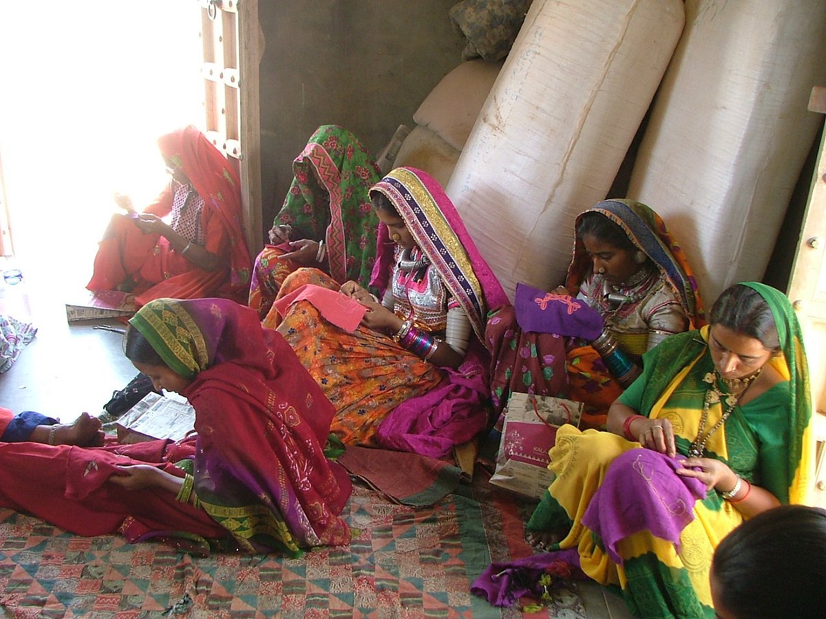 Artisans sit together to create Kala Rakshas fabric board games