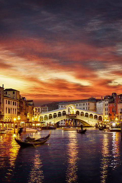 Ponte Rialto and gondola at sunset in Venice, Italy
