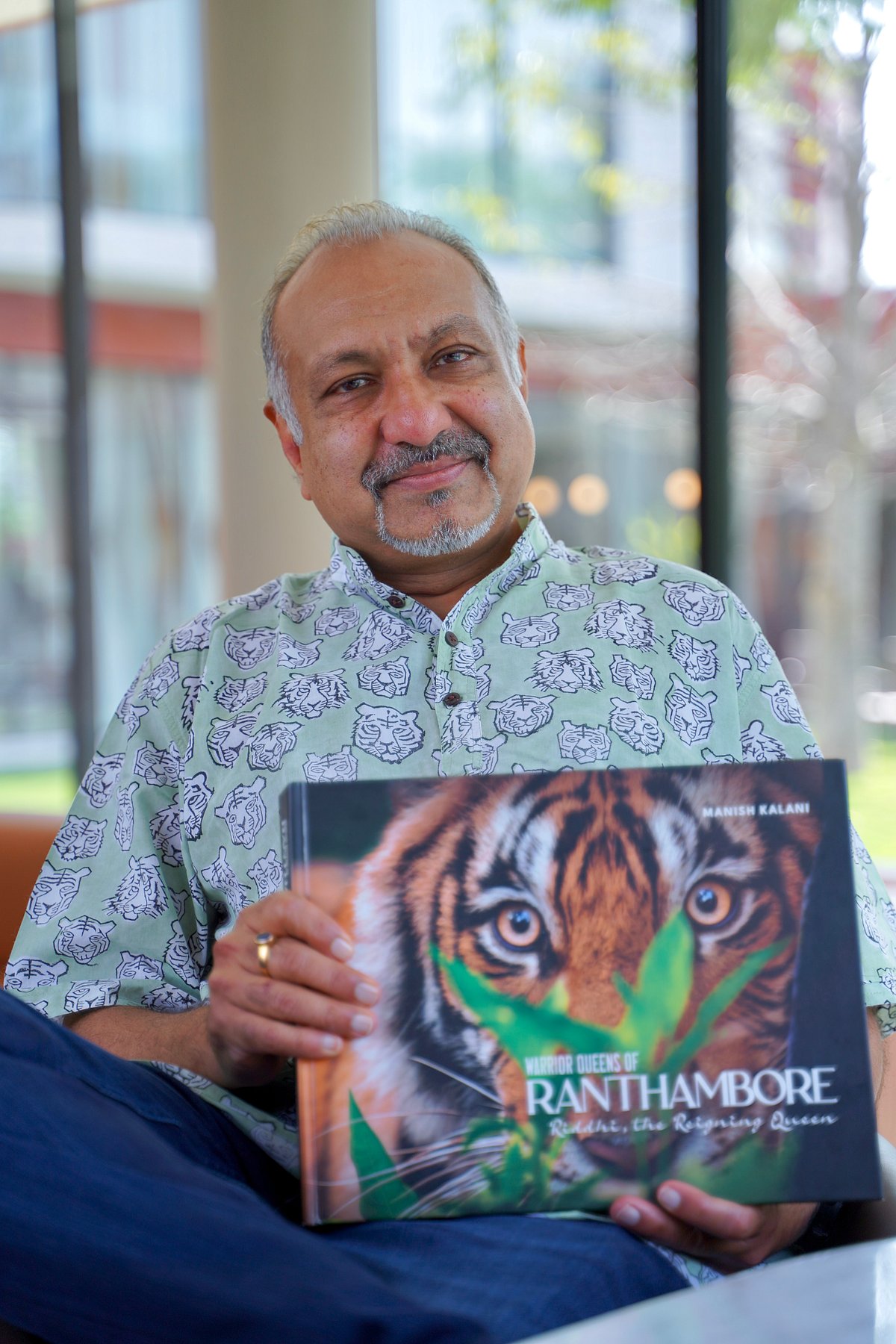 Wildlife photographer Manish Kalani holds a copy of his first coffee table book