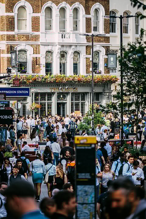 Busy London Street scene with crowds outside Farrington, London