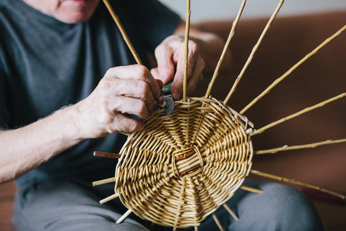 A man makes a wicker basket
