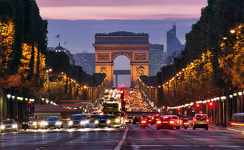 The Arc de Triomphe de l'Étoile stands at the western end of the Champs-Élysées in Paris.
