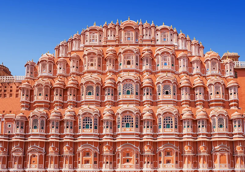 The small latticed windows of the Hawa Mahal, called jharokhas, resemble the crown of Lord Krishna