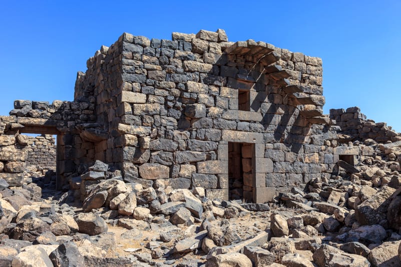 Ancient residents used the abundant black basalt from the region’s volcanic plain to construct sturdy, insulated structures