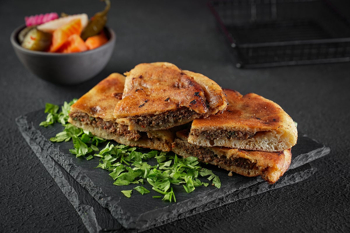 Hawawshi is a pita stuffed with minced meat and spiced with onions, pepper, and parsley