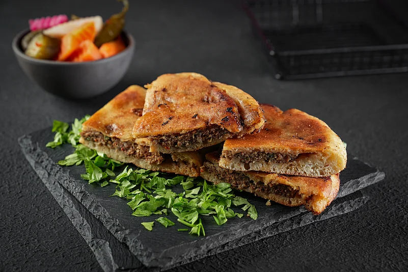 Hawawshi is a pita stuffed with minced meat and spiced with onions, pepper, and parsley