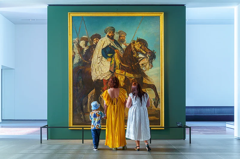People admiring an artwork at Louvre Abu Dhabi