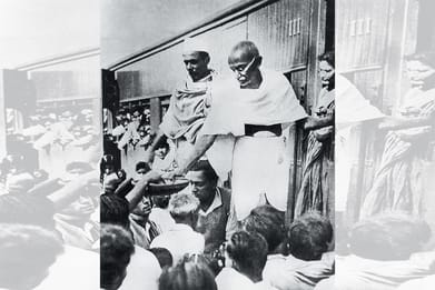 Photo: Getty Images : Gandhi at a railway station in Bengal, 1946