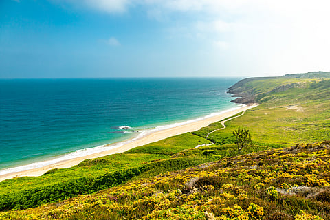 The pink sandstone cliffs of the Cap d’Erquy headland are crowned by wild moorlands