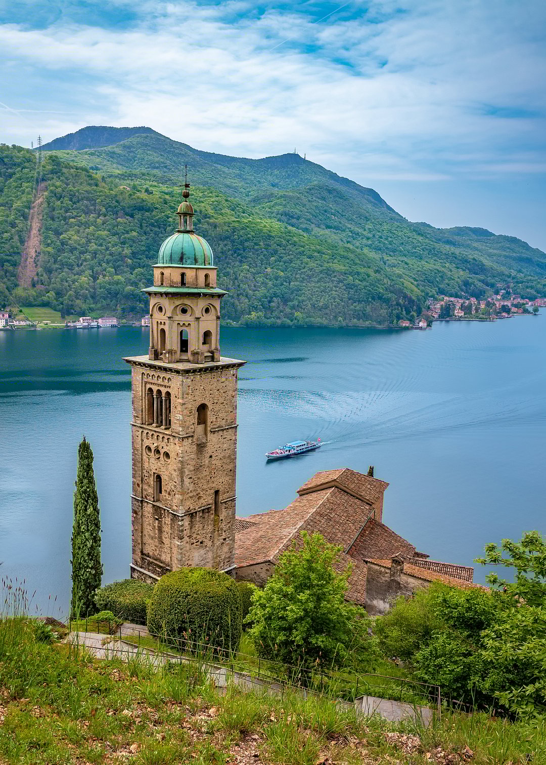 Landscape of Lake Lugano from Morcote village with the bell tower of the Santa Maria del Sasso church