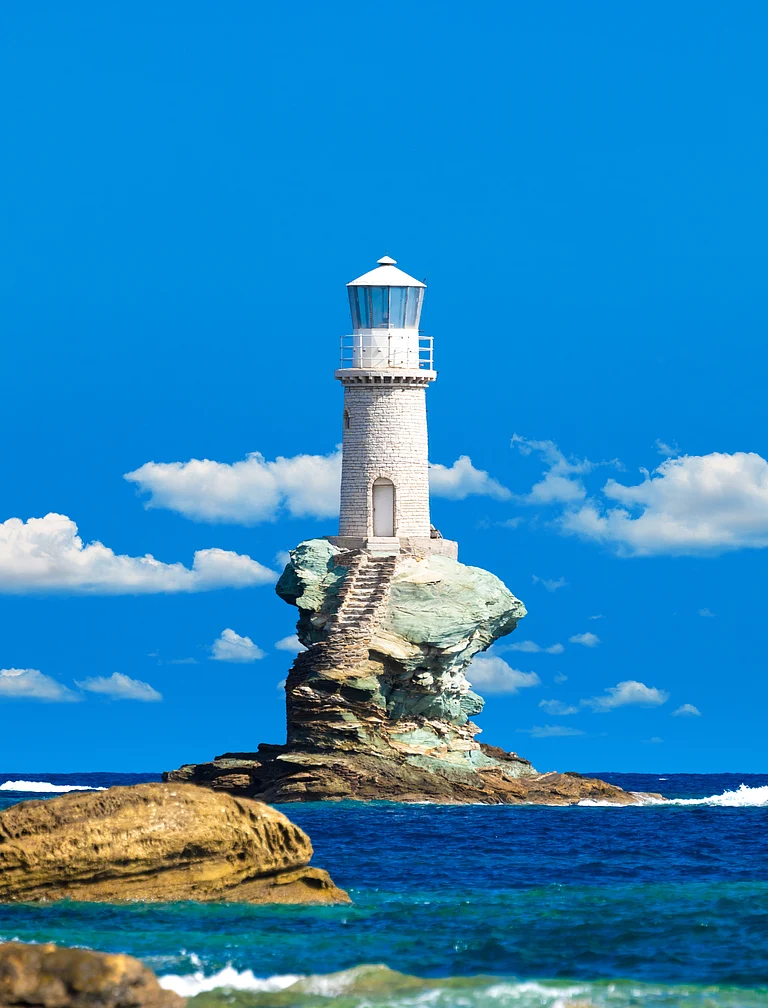 The beautiful Lighthouse Tourlitis of Chora in Andros island, Cyclades, Greece - Shutterstock