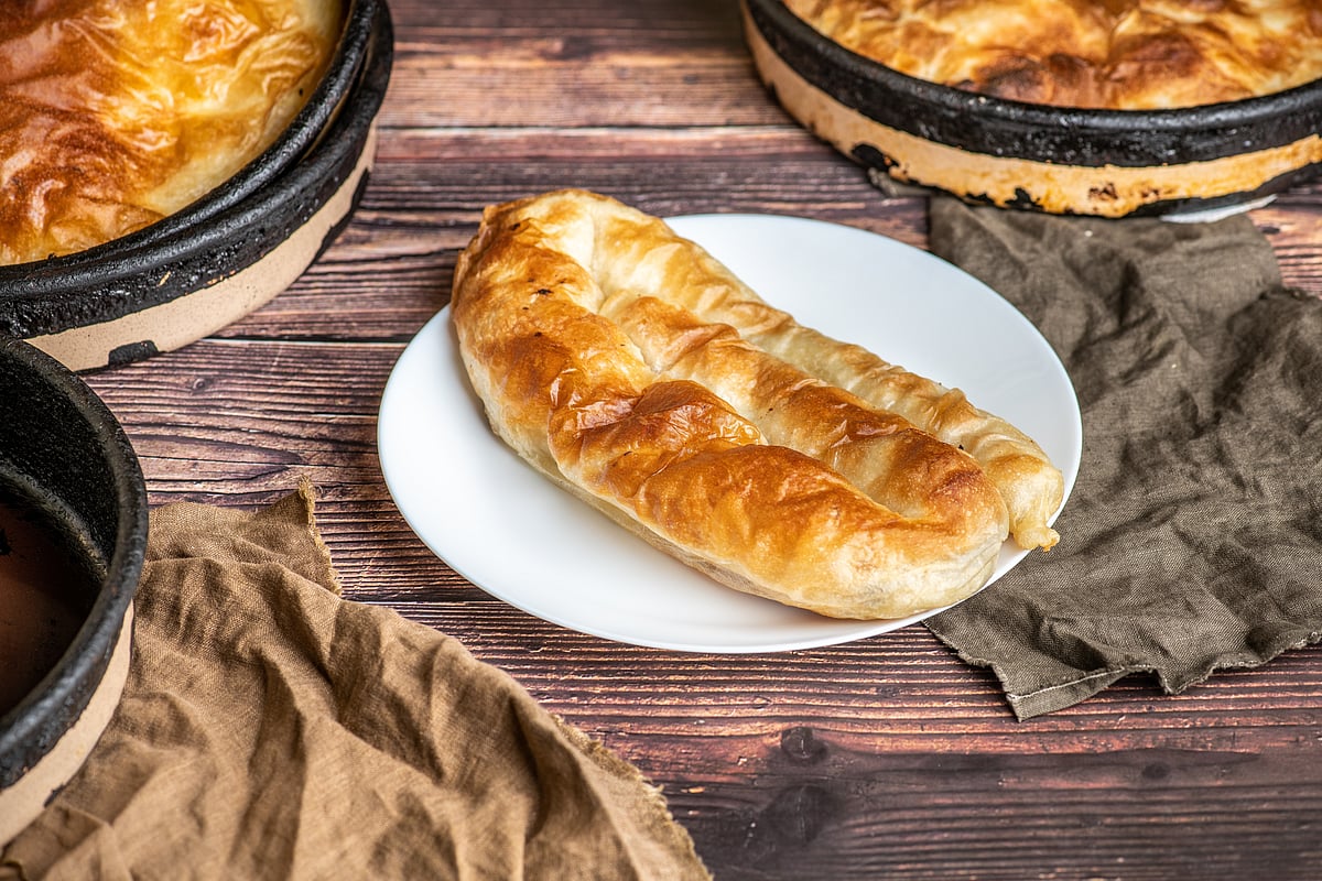 Burek is made of a thin flaky dough such as filo with a variety of fillings, such as meat, cheese, spinach or potatoes