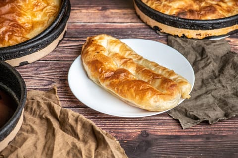 Burek is made of a thin flaky dough such as filo with a variety of fillings, such as meat, cheese, spinach or potatoes
