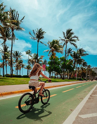 Shutterstock : Girl riding a bicycle summer Miami Beach, Florida