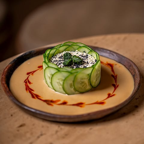 The "Gomae Salad" is a sesame based dressing topped with a tofu-cucumber crown and finished off with spinach and rayu