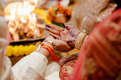 Shutterstock : An Indian couple gets married around a Vedic fire in a temple