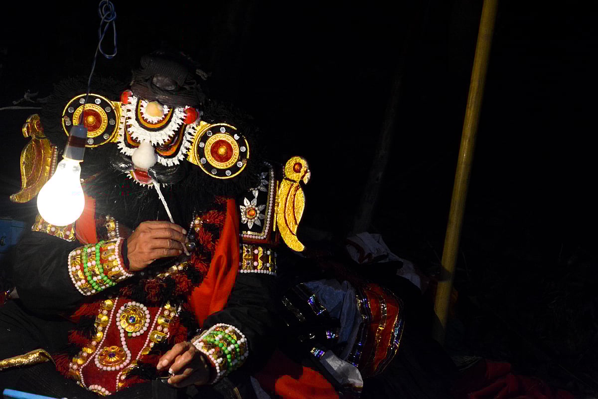 A yakshagana performer applies their make-up