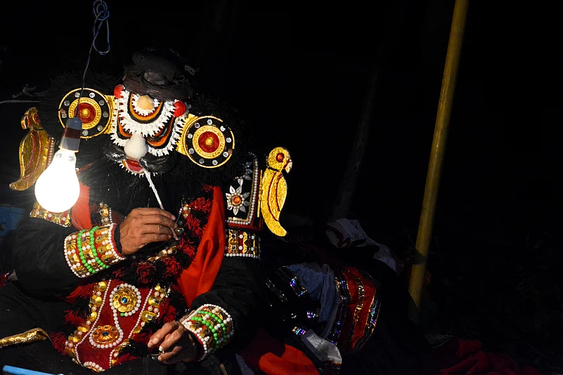 A yakshagana performer applies their make-up