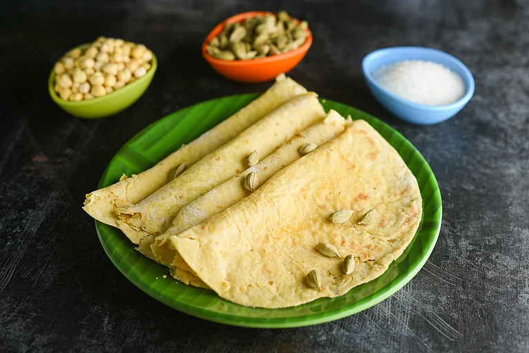 Boli is a sweet, refined flour paratha stuffed with mashed toor dal, jaggery, charoli, cardamom, nuts, and raisins - Shutterstock