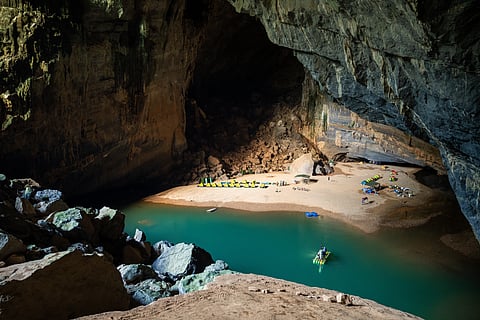 The highlight of a trek inside Hang Én is camping on a sandy beach beside an emerald pool