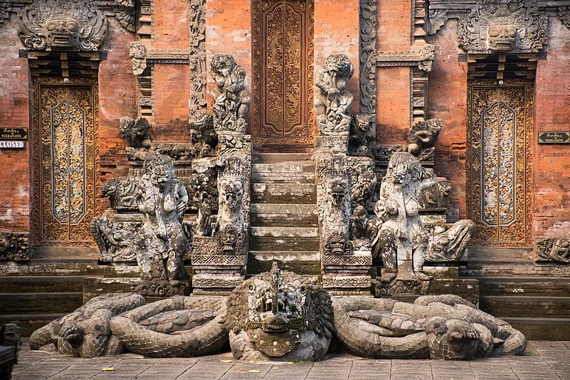 A temple with the many statues and guardians in front of the Hindu Temple at the sacred monkey forest in Ubud, Bali