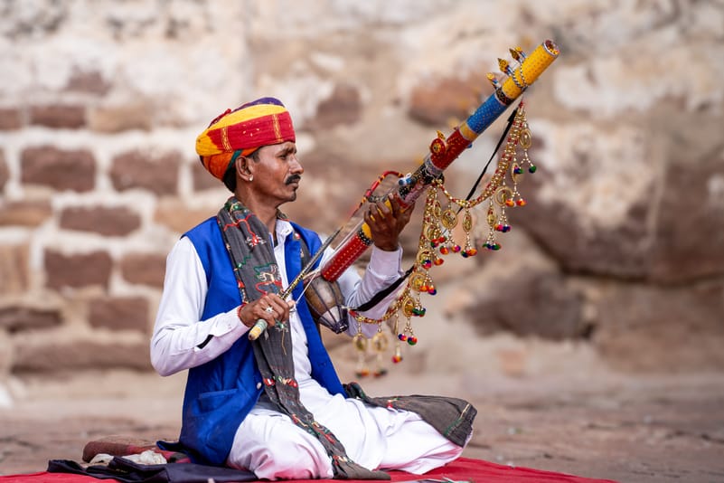 A Rajasthani singer sits wearing a traditional turban