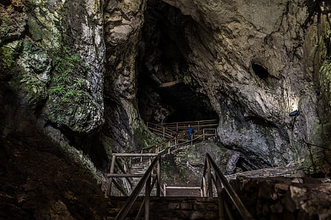 Heading inside Predjama Castle's cave