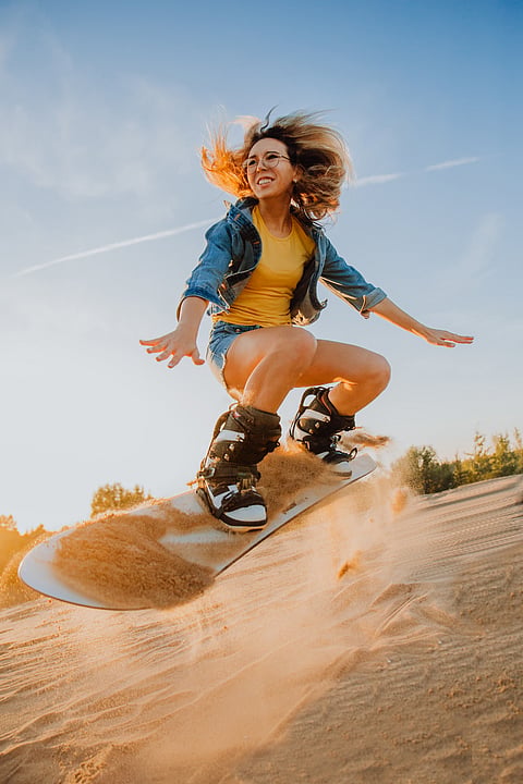 A tourist sandboards in Dubai