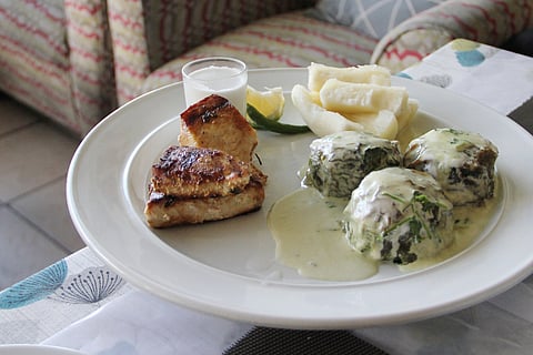 Rourou (taro leaves soaked in coconut milk) balls with grilled fish and steamed cassava