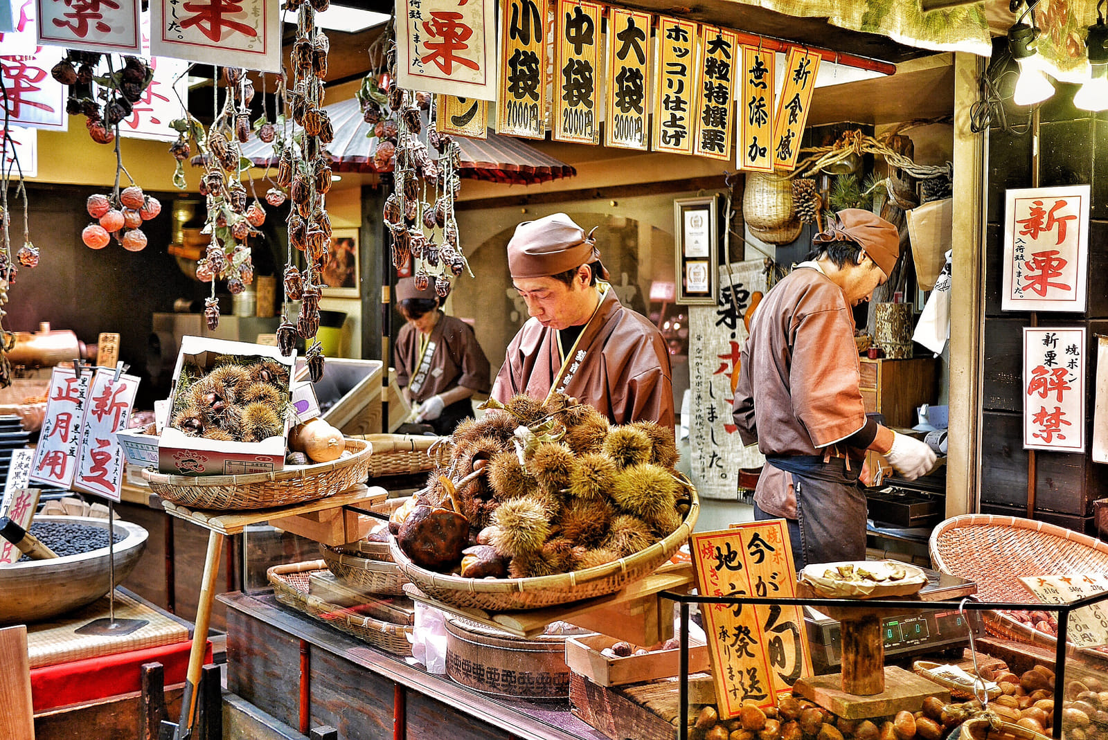 Vendors preparing chestnuts for sale at the Nishiki Food Market