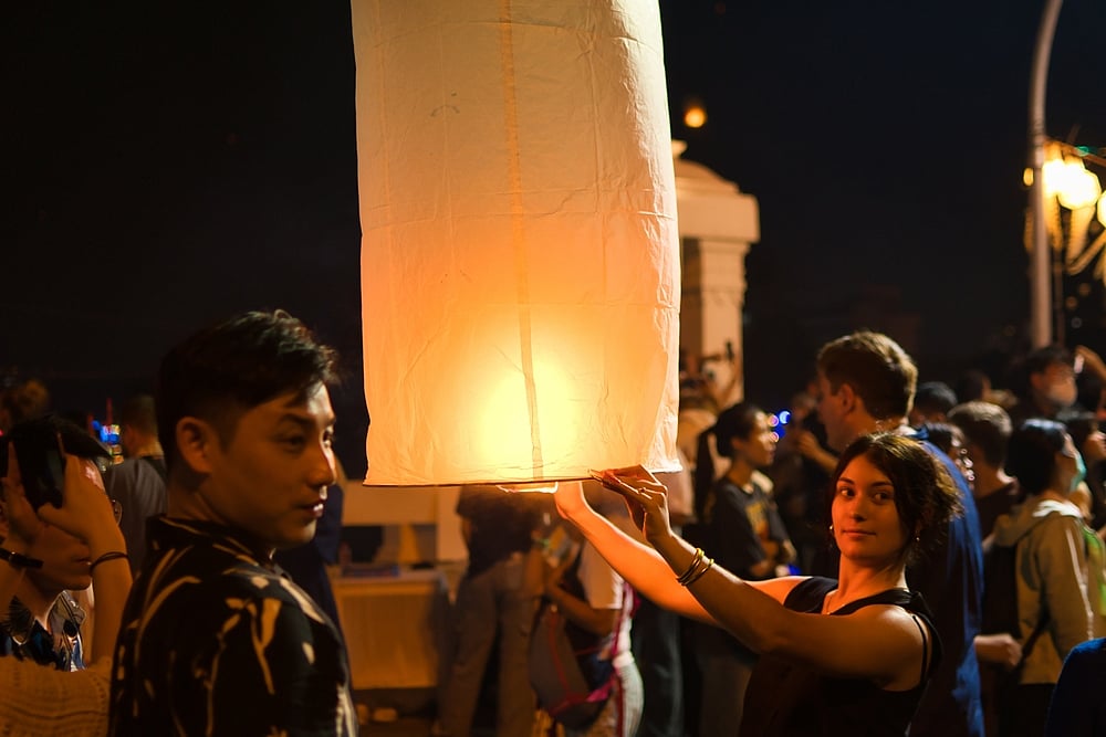 As the lanterns ascend, people make wishes and pray for a prosperous future