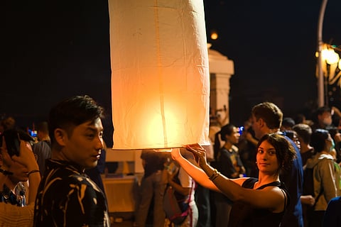 As the lanterns ascend, people make wishes and pray for a prosperous future