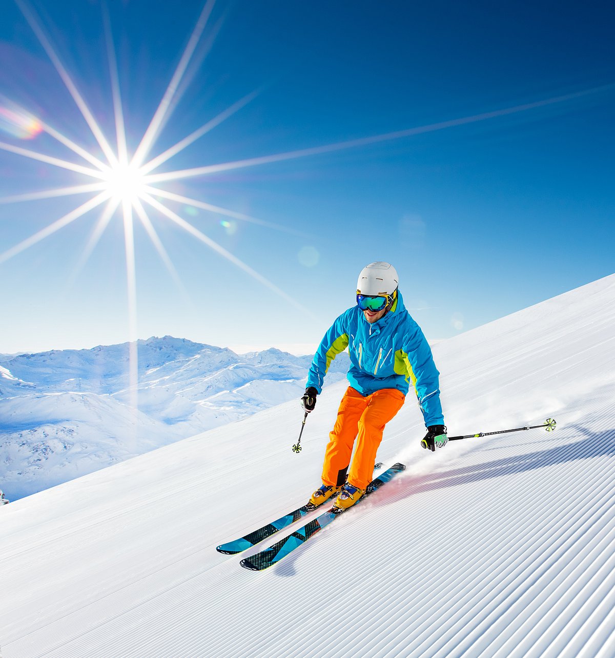 Shutterstock : Skier skiing downhill during sunny day in high mountains