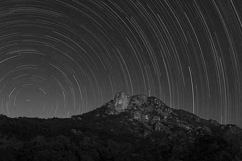Star trail over natural landmark Lion Rock in Hong Kong
