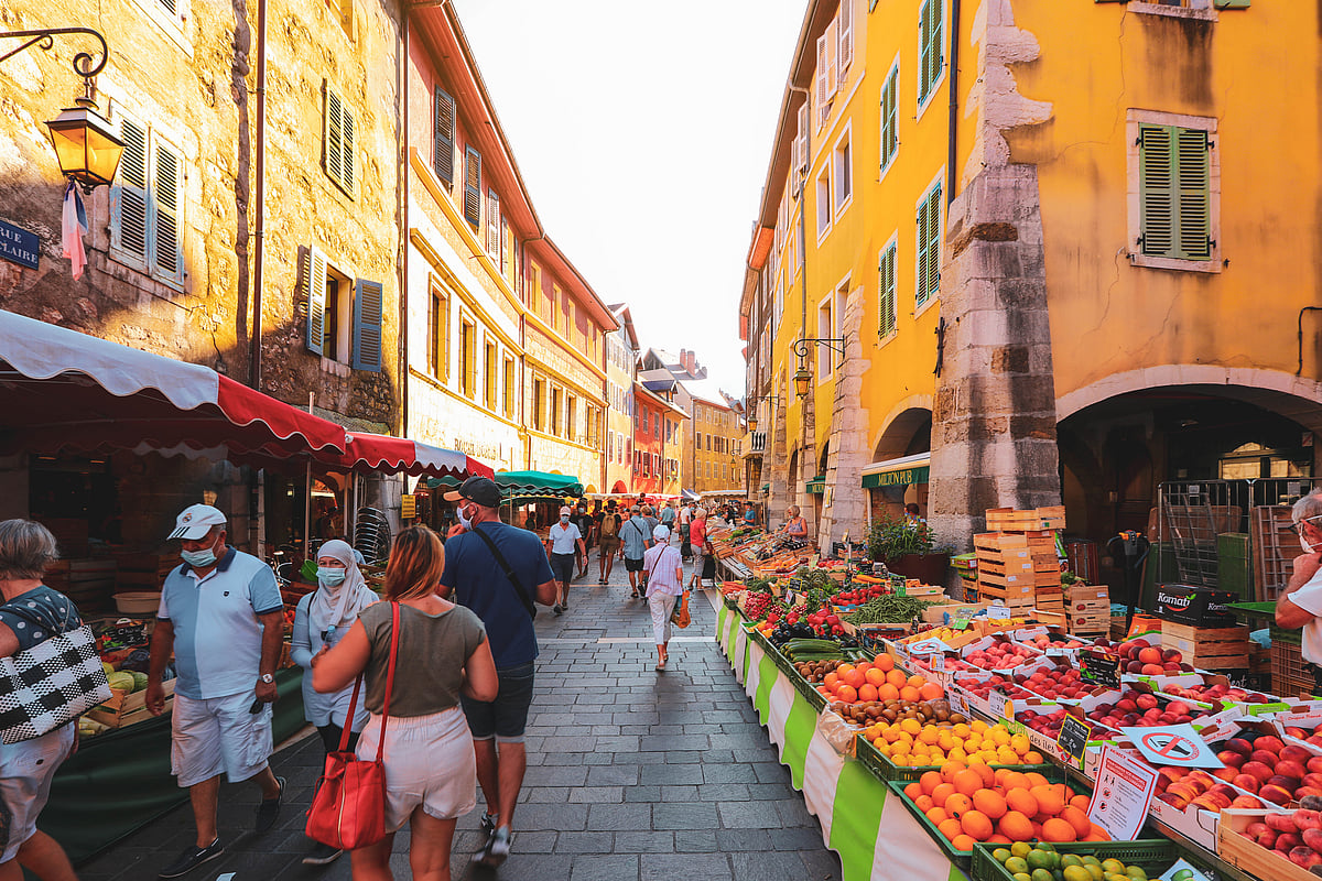 Morning street market vendors with fresh vegetables and fruits in Annecy