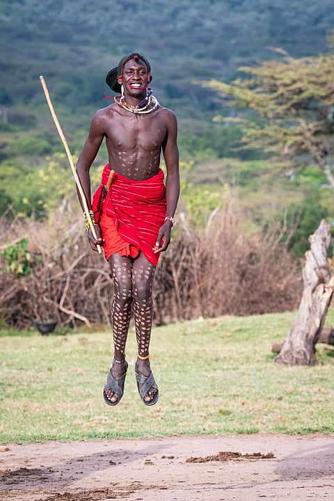 The Masai tribe, renowned for its ancient and vibrant culture, epitomizes a rich heritage in their unique attire and physical prowess. Their traditional garments, characterized by vividly coloured shúkās and intricate beadwork, reflect a deep cultural symbolism. The Masai's remarkable agility is equally striking; I witnessed a Masai warrior leap with such fluidity and grace that he appeared to float effortlessly in the air. This display of extraordinary physical flexibility and their distinctive attire offer a compelling testament to the tribe's enduring cultural legacy and dynamic vitality.