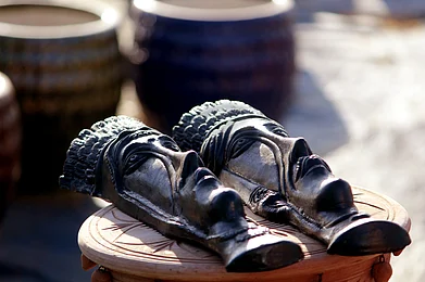 Radhavar/Shutterstock : Decorative tribal face masks made of earthen mud on sale in Indore