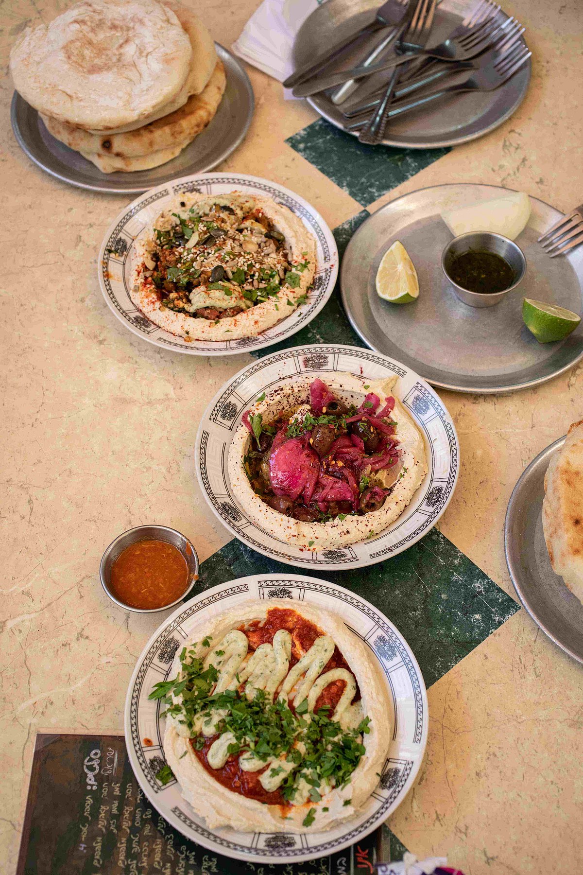 Dive into local specialties like fresh hummus, savory burekas, and sweet kanafeh