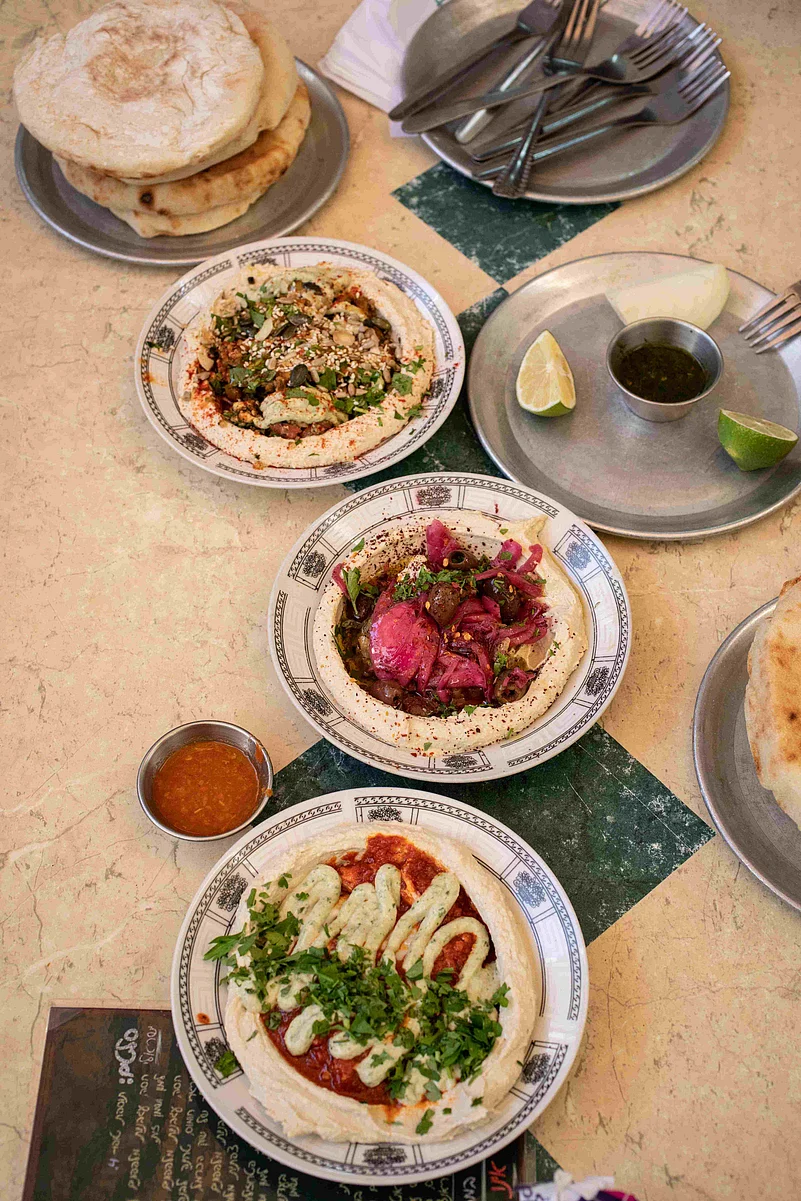 Dive into local specialties like fresh hummus, savory burekas, and sweet kanafeh