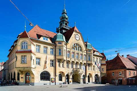 The yellow town hall dominates the town square (Mestni Trg) and is buzzing with activity